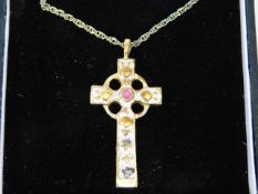 A silver gilt cross & chain set with small ruby