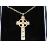 A silver gilt cross & chain set with small ruby