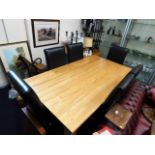 A contemporary oak dining table with six leather u