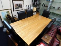 A contemporary oak dining table with six leather u