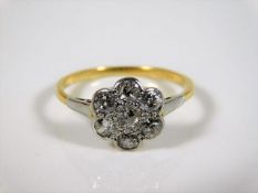 An 18ct gold daisy ring with approx. 0.7ct diamond