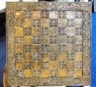 A large chess board with carved decor to outer 23.75in square, possibly by Jaques