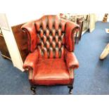 A leather wingback Chesterfield chair