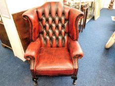 A leather wingback Chesterfield chair