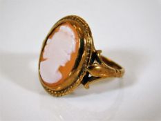 A small yellow metal ring set with cameo 3.1