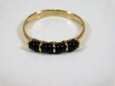 A 9ct gold ring set with round cut sapphires size