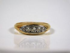 An 18ct gold ring set with five small white metal