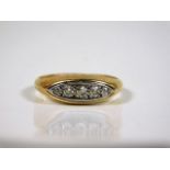 An 18ct gold ring set with five small white metal