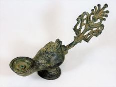An antique Roman style bronze oil lamp 9.5in long