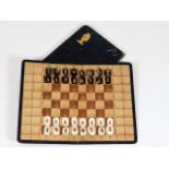 An early 20thC. leather portable chess set