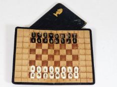 An early 20thC. leather portable chess set