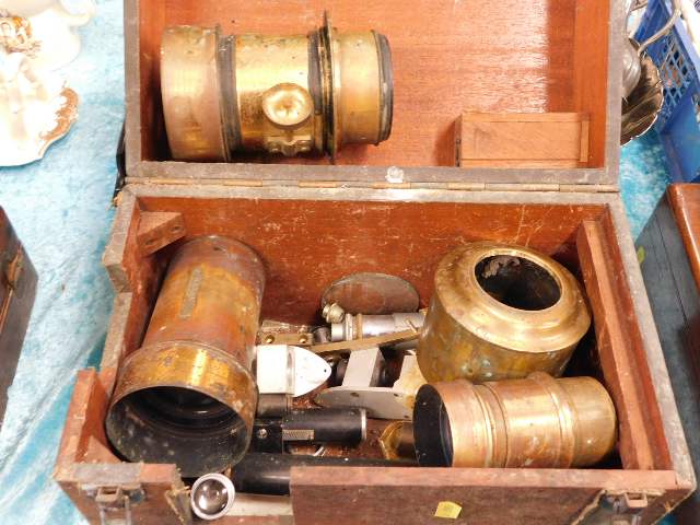 A boxed quantity of brass lenses & other related p