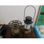 A brass Tilley style lamp twinned with a gas stove