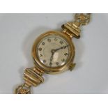 A ladies 9ct gold cased watch with plated strap
