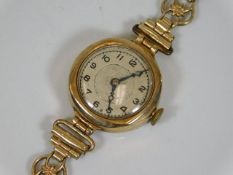 A ladies 9ct gold cased watch with plated strap