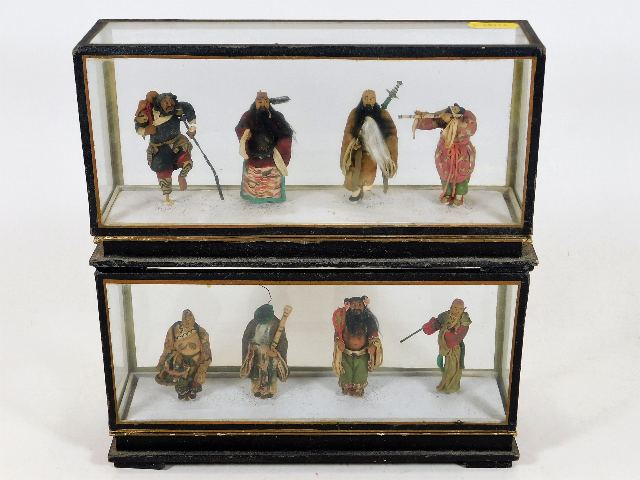 Two c.1900 cased groups of Tibetan style figures,