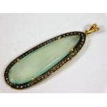 A yellow metal pendant with facet cut aqua quartz