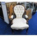 An elegant 19thC. upholstered armchair with button