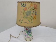 A mid 20thC. Poole Pottery lamp with original hand painted shade, some damage to shade