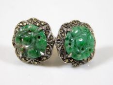 A pair of silver earrings set with carved jade & m