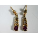 A pair of 9ct gold drop earrings set with ruby & s