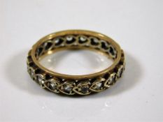 A 9ct gold eternity ring set with paste stones siz