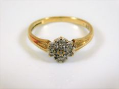 A yellow metal ring set with small diamonds 0.12ct