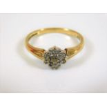 A yellow metal ring set with small diamonds 0.12ct