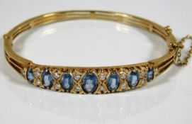 A good 9ct gold bangle set with approx. 5ct sapphi
