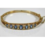 A good 9ct gold bangle set with approx. 5ct sapphi