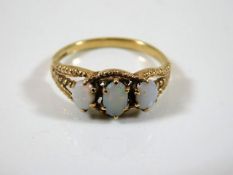 A small 9ct gold three stone opal ring size P 2.2g