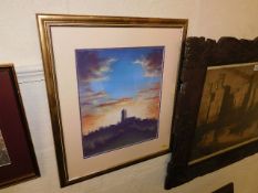 A framed pastel depicting a church & sunset scene