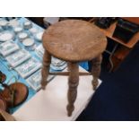 An antique elm farmhouse stool