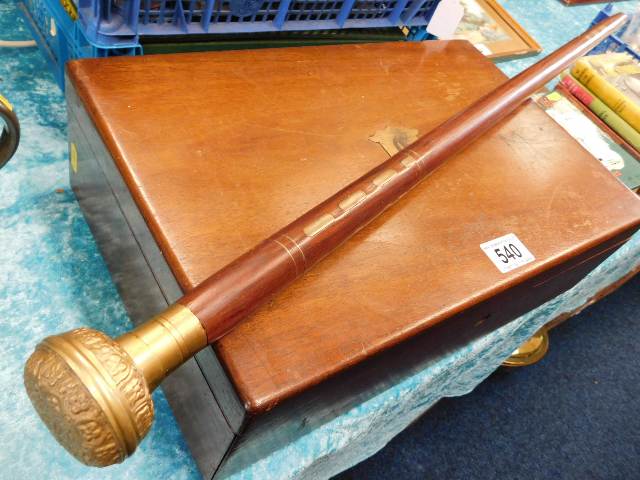 A brass handled walking cane