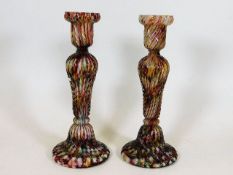 A pair of end of day glass candlesticks 9in high twinned with a pair of reticulated plates