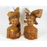 A pair of Balinese hardwood carved busts 12in high