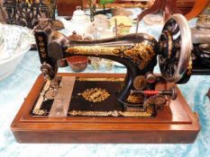 A Victorian Singer sewing machine with wooden stan