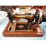 A Victorian Singer sewing machine with wooden stan