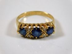An 18ct gold ring set with sapphire & small diamon