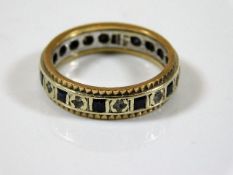 A 9ct two tone gold eternity ring set with sapphir