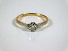 An 18ct gold solitaire ring with white metal mount