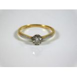 An 18ct gold solitaire ring with white metal mount