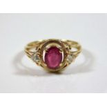 A decorative yellow metal ring set with ruby & dia
