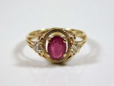 A decorative yellow metal ring set with ruby & dia