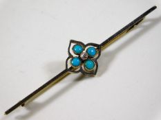 A yellow & white metal brooch set with turquoise &