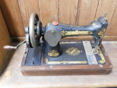 An early 20thC. Singer sewing machine with cover