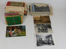 A quantity of European postcards & other items