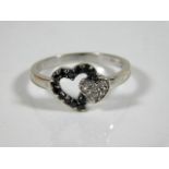 A 9ct white gold ring set with black & white diamo