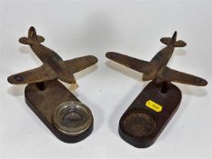 A pair of WW2 wooden spitfires, one lacking glass