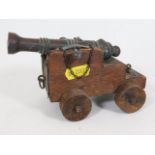 A oak mounted miniature desk cannon